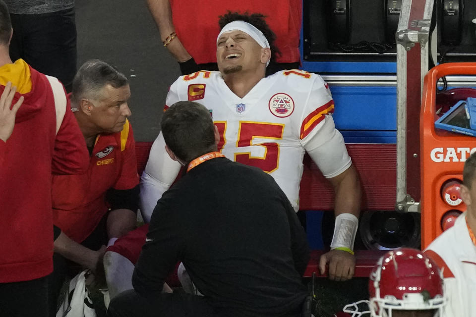 Kansas City Chiefs quarterback Patrick Mahomes (15) grimaces on the bench after an injury during the first half of the NFL Super Bowl 57 football game against the Philadelphia Eagles, Sunday, Feb. 12, 2023, in Glendale, Ariz. (AP Photo/Charlie Riedel)