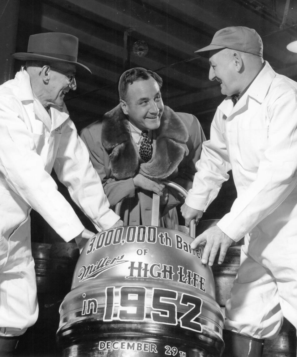 Miller Brewing Co. President Frederick C. Miller, center, helps roll out the Milwaukee brewery's three millionth barrel of beer of the year in this 1952 photo.