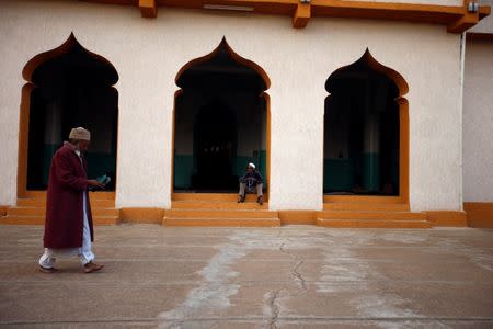 A faithful walks by a Mosque within the walled city of Harar, Ethiopia, February 24, 2017. REUTERS/Tiksa Neger