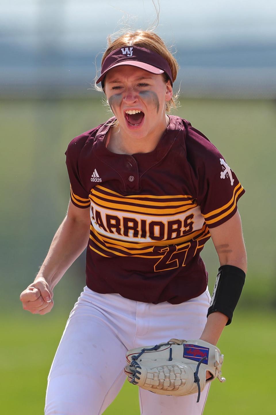 Walsh Jesuit shortstop Keeley Clinton celebrates after beating Painesville Riverside, 4-2, in a Division I district semifinal softball game at Massillon High School on Monday.