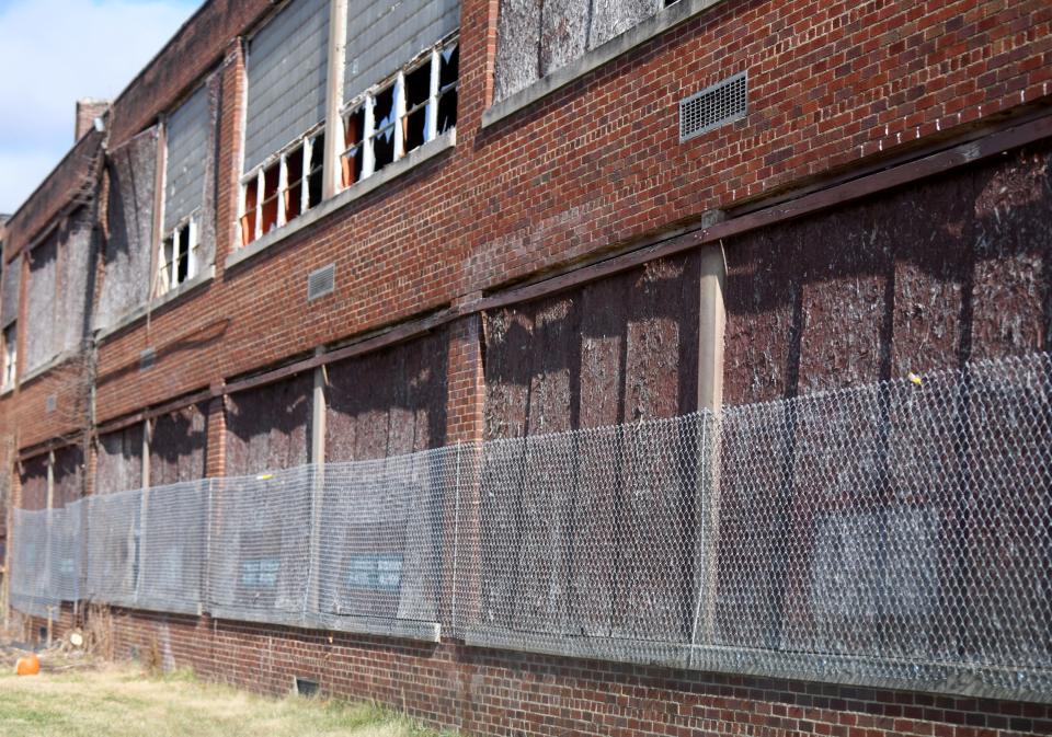 The former North Industry School which Canton Township officials hope to demolish in the near future having put the fencing over the windows to keep intruders from going inside. Thursday, December 01, 2022.