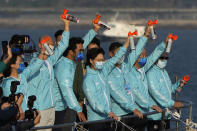 Hong Kong Chief Executive Carrie Lam, center, attends a harbor race at the Victoria Harbor in Hong Kong, Sunday, Dec. 12, 2021. Hundreds of people took part in traditional swim across iconic Victoria Harbor after two years of suspension. (AP Photo/Kin Cheung)