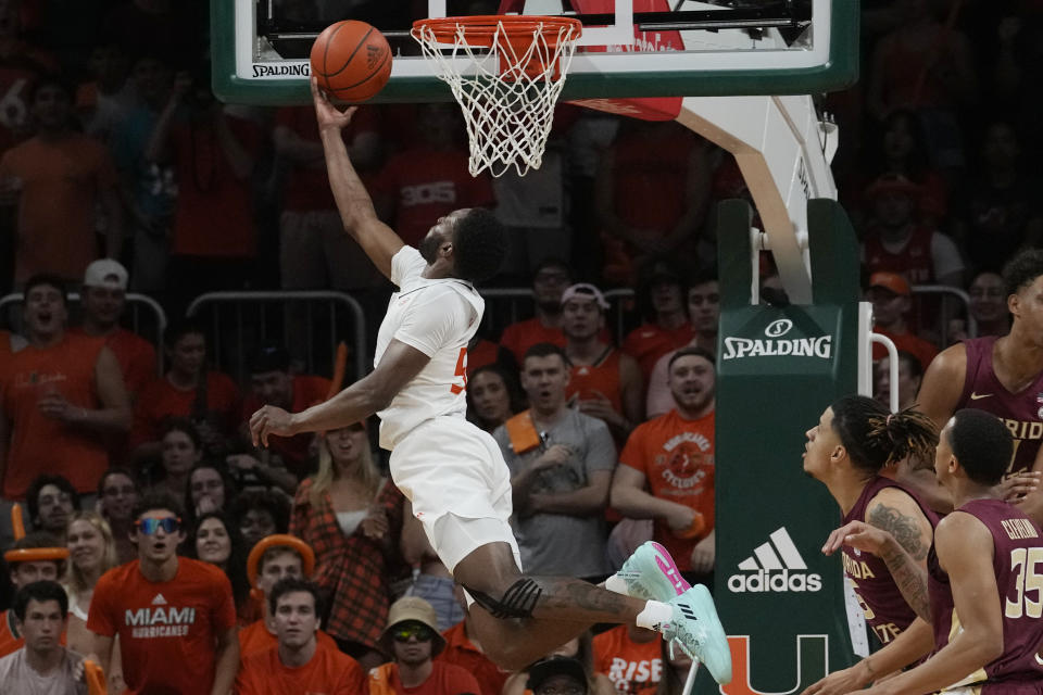 Miami guard Wooga Poplar (55) drives to the basket during the first half of an NCAA college basketball game against Florida State , Saturday, Feb. 25, 2023, in Coral Gables, Fla. (AP Photo/Marta Lavandier)