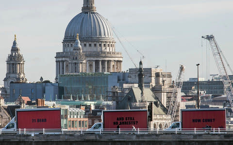 The Community-led organisation, Justice4Grenfell, parades three billboards backdropped by St. Paul's Cathedral - Credit: AP