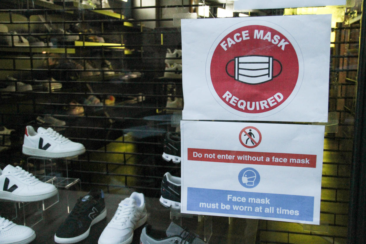  A sign outside a shop in Bricklane reminds customers to wear a face mask. The Government has made it mandatory to wear face coverings in all public transport, supermarkets and indoor shopping centers as a measure to combat the spread of the novel coronavirus. (Photo by David Mbiyu / SOPA Images/Sipa USA) 