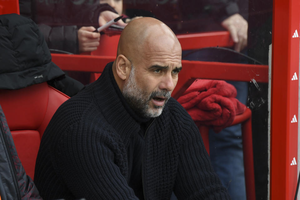 Manchester City's head coach Pep Guardiola sits on the bench prior to the English Premier League soccer match between Nottingham Forest and Manchester City at the City Ground stadium in Nottingham, England, Sunday, April 28, 2024. (AP Photo/Rui Vieira)