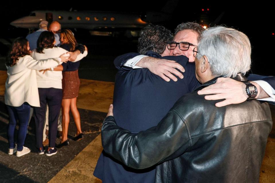 PHOTO: Family members embrace freed Americans Siamak Namazi, Morad Tahbaz and Emad Shargi as well as two returnees whose names have not yet been released by the U.S. government at Davison Army Airfield at Fort Belvoir, Va., Sept. 19, 2023. (Jonathan Ernst/Reuters)