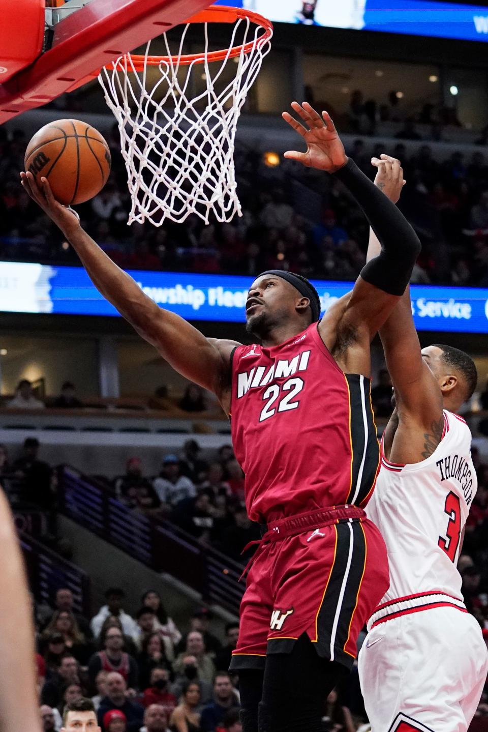 Miami Heat forward Jimmy Butler, left, drives to the basket past Chicago Bulls center Tristan Thompson during the first half of an NBA basketball game in Chicago, Saturday, April 2, 2022. (AP Photo/Nam Y. Huh)