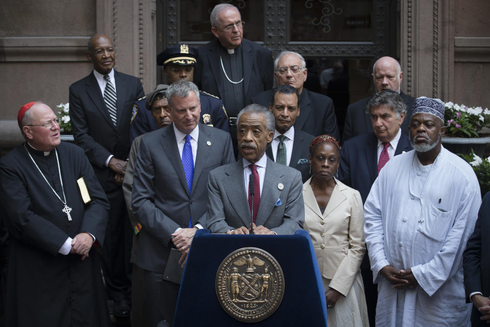 Rev. Al Sharpton alongside Catholic Cardinal Timothy Dolan, left, New York City Mayor Bill de Blasio, center left, first lady Chirlane McCray, center right, and Imam Talib Al-Hajj Abdur-Rashid, right, following a multi-faith meeting in August 2014 spawned by the death of Eric Garner. (Photo: John Minchillo/AP)