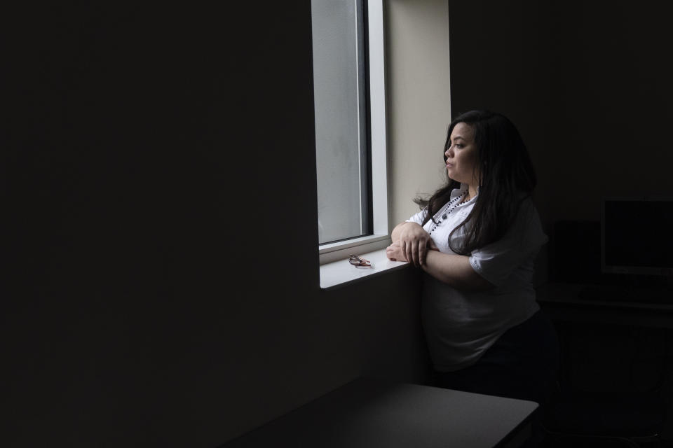 Crystal Martinez looks out of a window after speaking about her experiences with domestic violence and life in prison without her children Friday, Jan. 26, 2024, at Logan Correctional Center in Lincoln, Ill. Martinez's eight-year sentence for shooting a man she said was beating his girlfriend at the time was recently reduced under an Illinois law that allows survivors of domestic violence to ask for shorter sentences. (AP Photo/Erin Hooley)
