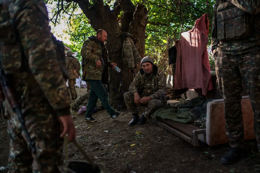 HADRUT, NAGORNO-KARABAKH -- OCTOBER 13, 2020: Soldiers stay under the cover of trees as a Azerbaijan drone flies occasionally flies overhead near Hadrut, Nagorno-Karabakh, which is also internationally recognized as part of Azerbaijan, on Tuesday Oct. 13, 2020. The conflict, which began on Sept, 27, is between Azerbaijani and Armenian forces over Nagorno-Karabakh D a disputed region, and has killed hundreds including dozens of civilians from both sides. (Marcus Yam / Los Angeles Times)