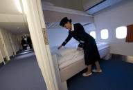 Local Manager Gisela Olsson makes a bed in one of the standard rooms in the Jumbo Hostel at Arlanda Airport, Stockholm January 14, 2009. Jumbo Hostel is a Boeing 747-200 jumbo jet that has been converted into a 25 room hotel and cafe and the cockpit has been converted into a de luxe suite. REUTERS/Fredrik Sandberg/SCANPIX