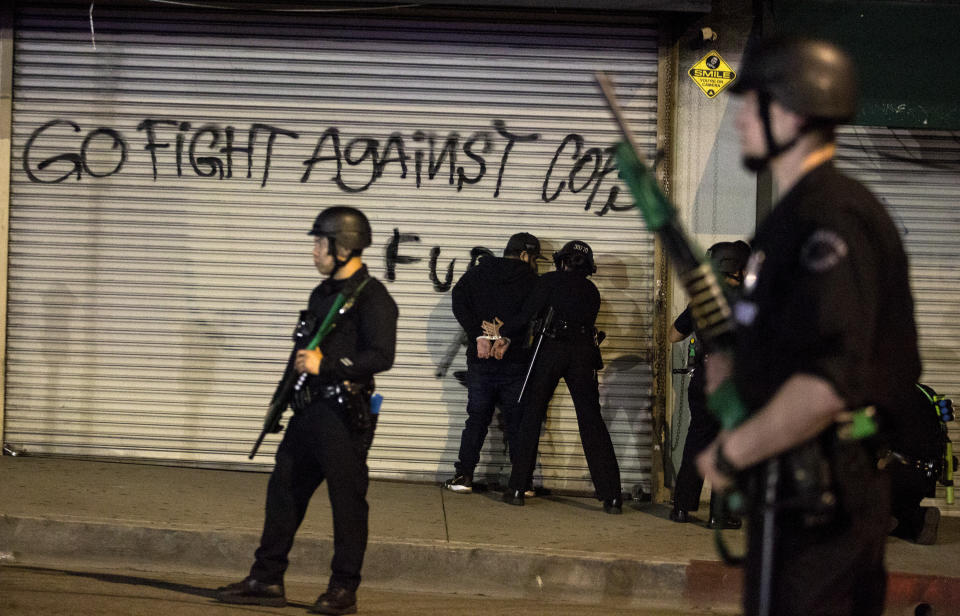 Police officers arrest a protester Sunday, May 31, 2020, in Los Angeles, during a demonstration over the death of George Floyd, who died May 25 after he was pinned at the neck by a Minneapolis police officer. (AP Photo/Ringo H.W. Chiu)