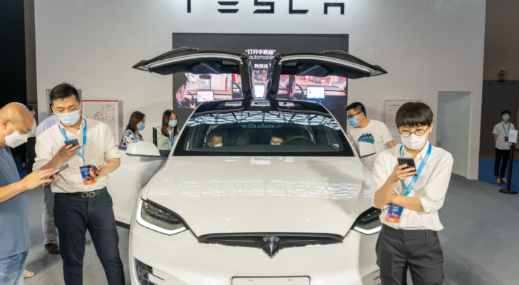 Tesla (TSLA) model X displayed in China auto expo during covid19 pandemic. Staff wearing face mask.
