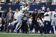 Dallas Cowboys cornerback Trevon Diggs (7) intercepts a pass intended for Washington Commanders wide receiver Jahan Dotson (1) in the first half of a NFL football game in Arlington, Texas, Sunday, Oct. 2, 2022. (AP Photo/Michael Ainsworth)