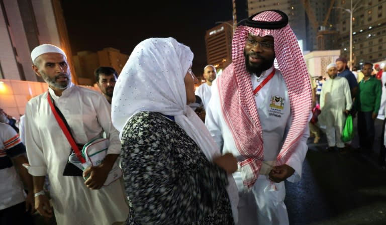 A Muslim pilgrim speaks to a translator in the Saudi holy city of Mecca ahead of the start of the hajj pilgrimage