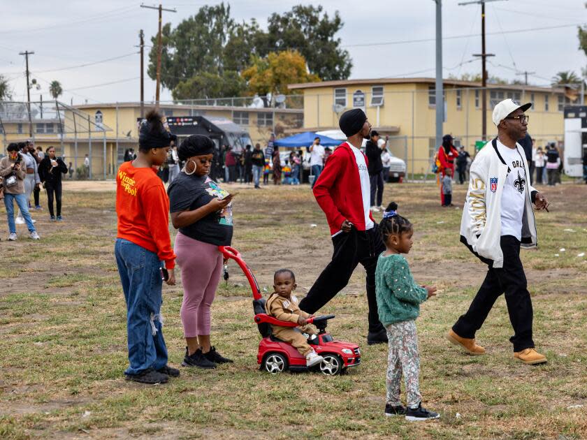 Residents of the Nickerson Gardens housing project gather for Top Dawg Entertainment's annual toy drive and concert Tuesday in Los Angeles.