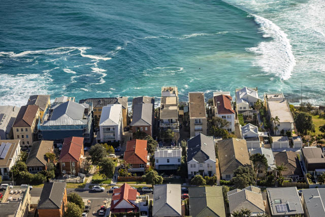 Aerial photography of houses and apartments on coastline with ocean, surf, waves. Brighton Blvd, Ramsgate Ave, North Bondi, Sydney, Australia