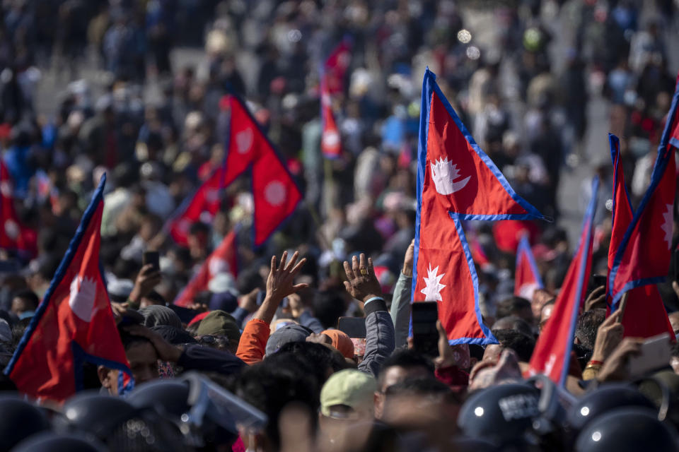 Protesters participate in a rally demanding a restoration of Nepal's monarchy in Kathmandu, Nepal, Thursday, Nov. 23, 2023. Riot police used batons and tear gas to halt tens of thousands of supporters of Nepal's former king demanding the restoration of the monarchy and the nation's former status as a Hindu state. Weeks of street protests in 2006 forced then King Gyanendra to abandon his authoritarian rule and introduce democracy. (AP Photo/Niranjan Shrestha)