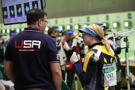 Aug 6, 2016; Rio de Janeiro, Brazil; Virginia Thrasher (USA) with a USA Olympic member during the 10m air rifle qualification at Olympic Shooting Centre. Mandatory Credit: Geoff Burke-USA TODAY Sports