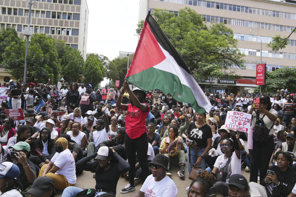 A protester holds a Palestinian flag during a procession to protest against the rising cases of femicide, in downtown Nairobi, Kenya Saturday, Jan. 27, 2024. Thousands of people marched in cities and towns in Kenya during protests Saturday over the recent slayings of more than a dozen women. The anti-femicide demonstration was the largest event ever held in the country against sexual and gender-based violence. (AP Photo/Brian Inganga)