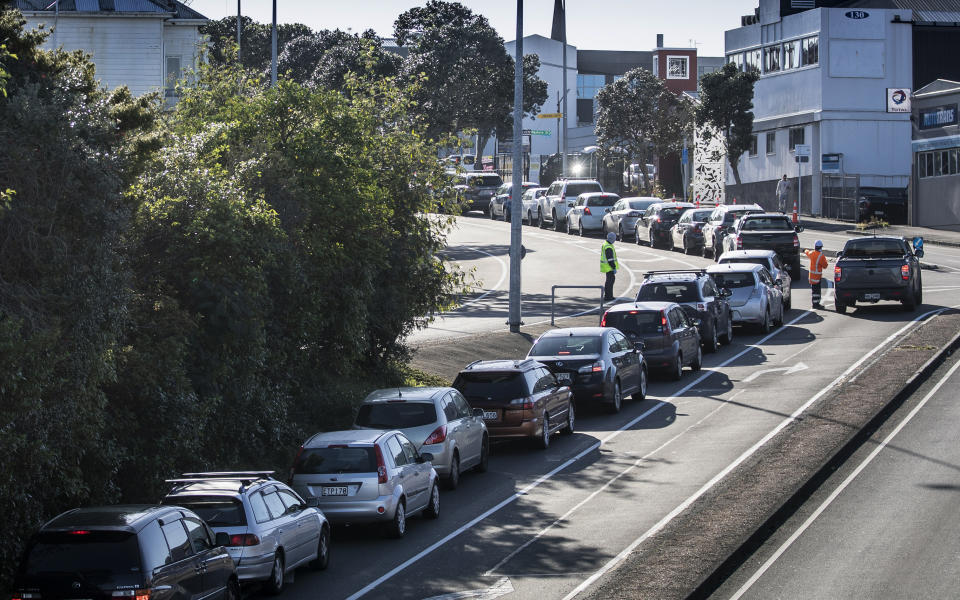 Cars queue at a COVID-19 test centre in Auckland, New Zealand, Thursday, Aug. 13, 2020. Health authorities in New Zealand are scrambling to trace the source of a new outbreak of the coronavirus as the nation's largest city goes back into lockdown. (AP Photo/Greg Bowker)