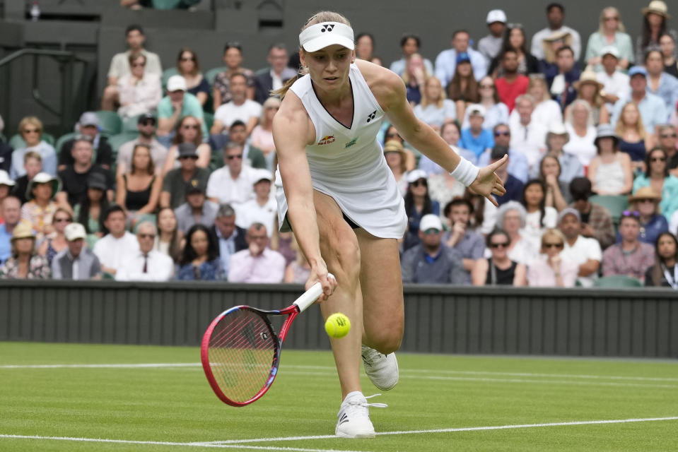 Kazakhstan's Elena Rybakina returns to Tunisia's Ons Jabeur in a women's singles match on day ten of the Wimbledon tennis championships in London, Wednesday, July 12, 2023. (AP Photo/Kirsty Wigglesworth)