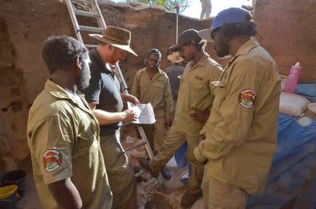 A supplied image shows Chris Clarkson talking with local Djurrubu Aboriginal Rangers Vernon Hardy, Mitchum Nango, Jacob Baird, and Claude Hardy during excavations at the Madjedbebe site located in the Kakadu region in northern Australia June 29, 2015 which has revelead that humans reached the country at least 65,000 years ago - up to 18,000 years earlier than archaeologists previously thought. Dominic O'Brien-Gundjeihmi Aboriginal Corporation/Handout via REUTERS