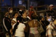 Relatives of inmates wait for news outside the Litoral penitentiary after a riot, in Guayaquil, Ecuador, Tuesday, Sept. 28, 2021. A police and military operation managed to regain control of the regional prison after five hours, according to a statement from Ecuador’s prison service, but reported at least 24 dead and 48 injured during the riot. (AP Photo/Angel DeJesus)