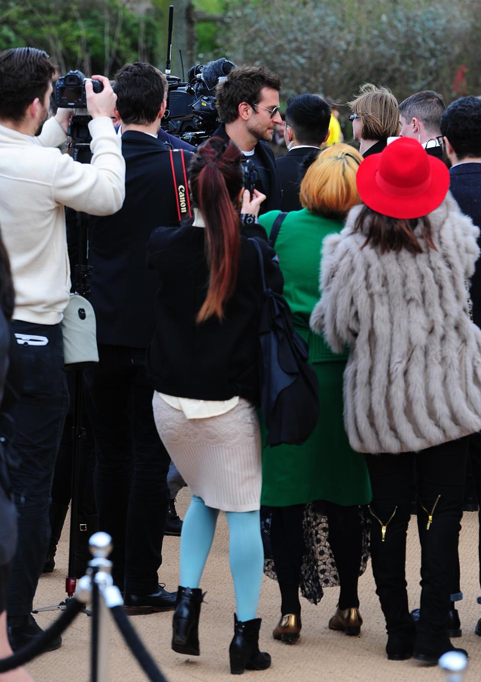 U.S actor Bradley Cooper, center, is photographed arriving for the Burberry Prorsum autumn/winter 2014 London Fashion Week show at Kensington Gardens, London, Monday, Feb. 17, 2014. (AP Photo/Ian West, PA Wire) UNITED KINGDOM OUT - NO SALES - NO ARCHIVES