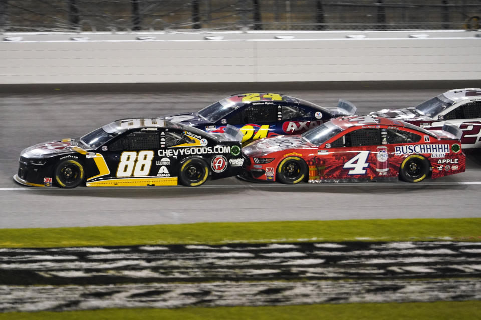 Alex Bowman (88), William Byron (24) and Kevin Harvick (4) battle during a NASCAR Cup Series auto race at Kansas Speedway in Kansas City, Kan., Thursday, July 23, 2020. (AP Photo/Charlie Riedel)