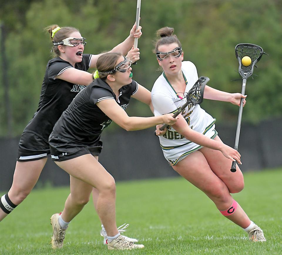 Notre Dame's Madelyn Dugan is pressured by Nipmuc defenders Elizabeth Lange, left, and Madelyn Weibe, as she moves in for a shot on goal.