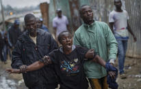 <p>A woman wails and screams at police, near to the body of a man who had been shot in the head and who the crowd claimed had been shot by police, in the Mathare slum of Nairobi, Kenya Wednesday, Aug. 9, 2017. Kenya’s election took an ominous turn on Wednesday as violent protests erupted in the capital. (Photo: Ben Curtis/AP) </p>