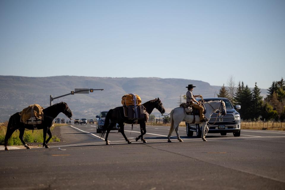 Jake Harvath crosses U.S. 189 in Heber City as he sets out on the first morning of a year-ong horse ride across the country on Monday, Sept. 25, 2023. | Spenser Heaps, Deseret News