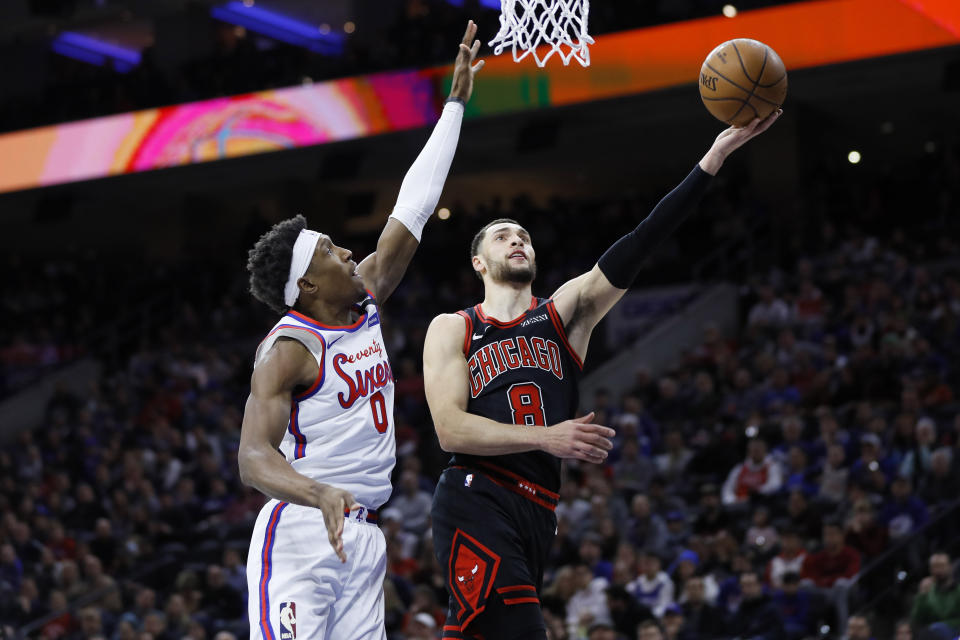 Chicago Bulls' Zach LaVine, right, goes up to shoot against Philadelphia 76ers' Josh Richardson during the first half of an NBA basketball game, Friday, Jan. 17, 2020, in Philadelphia. (AP Photo/Matt Slocum)