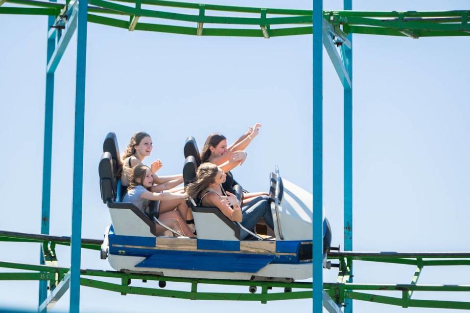 Brooklyn Mercado, back left, Aria Black, 8, front left, Sasha Allen, 14, back right, and Amy Brockmeyer, front right, ride the X Scream Machine Coaster at the California State Fair on Tuesday. Mercado said her favorite part of the day was screaming during the various rides.