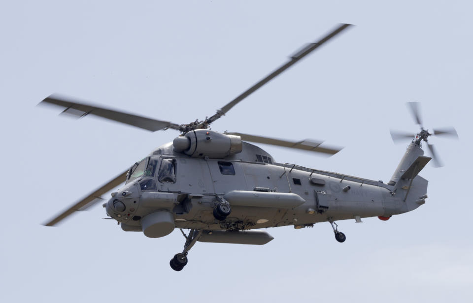 A Navy helicopter returns to Whakatane Airport following the recovery operation to return the victims of the Dec. 9 volcano eruption continues off the coast of Whakatane New Zealand, Friday, Dec. 13, 2019. A team of eight New Zealand military specialists landed on White Island early Friday to retrieve the bodies of victims after the Dec. 9 eruption. (AP Photo/Mark Baker)