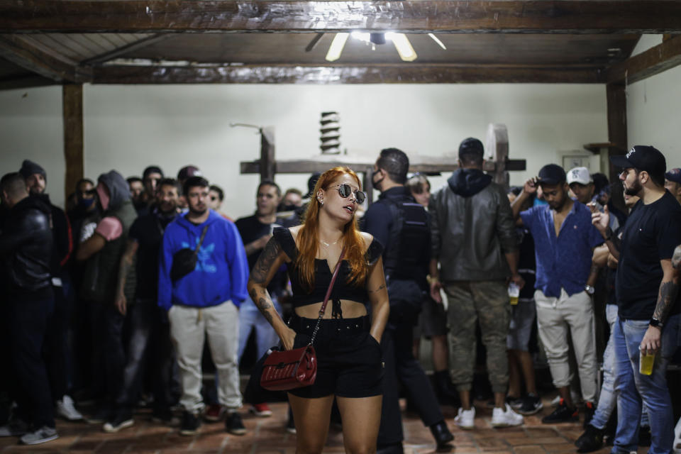 Police break up a social gathering during an operation against illegal and clandestine gatherings that authorities believe are partly responsible for fueling the spread of COVID-19, at a party hall in Sao Paulo, Brazil, early Saturday, April 17, 2021. (AP Photo/Marcelo Chello)