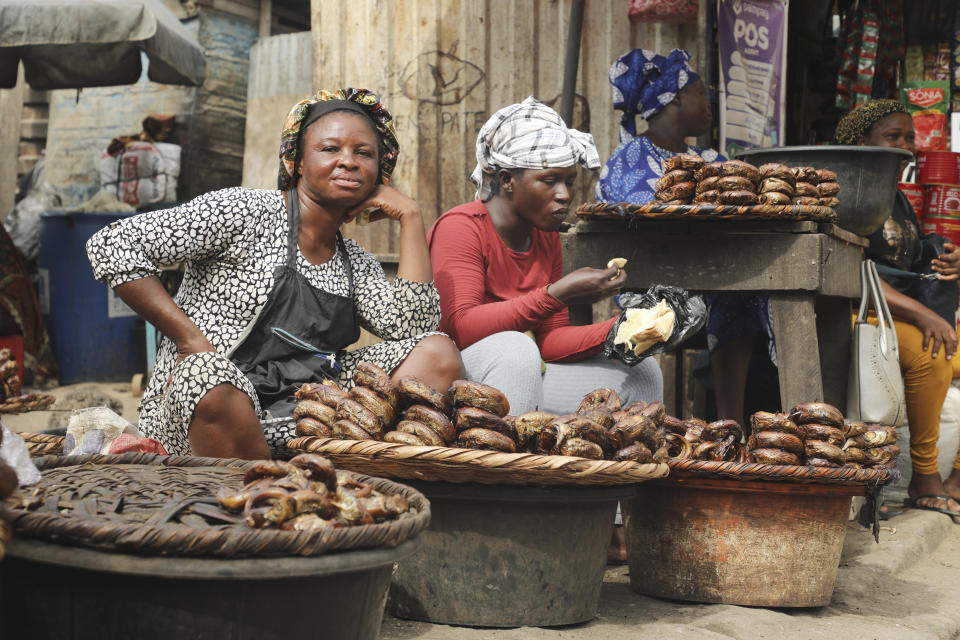 Women sell smoked fish at a Mile 12 Market in Lagos, Nigeria, Friday, Feb. 16, 2024. Nigerians are facing one of the West African nation's worst economic crises in as many years triggered by a surging inflation rate which follows monetary policies that have dipped the local currency to an all-time low against the dollar, provoking anger and protests across the country. (AP Photo/Mansur Ibrahim)