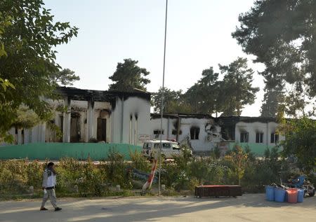 An Afghan man walks in front of the Medecins Sans Frontieres (MSF) hospital in Kunduz, Afghanistan October 14, 2015. Medecins Sans Frontieres said on Wednesday that an international humanitarian commission has been formally asked to investigate the U.S. bombing of its hospital in Kunduz, Afghanistan, that killed 22 people including 12 of its staff. REUTERS/Stringer