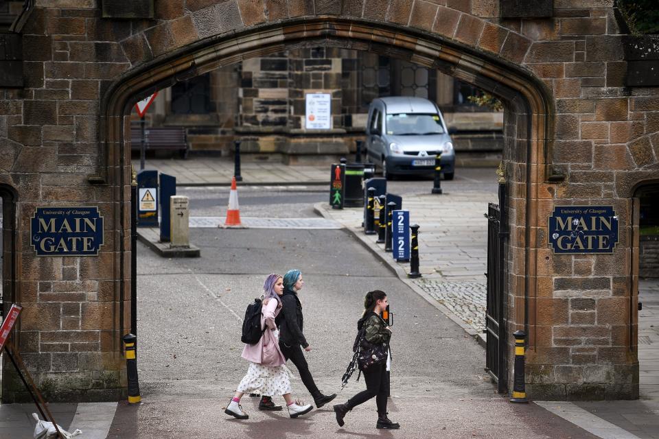 Members of the public walk past the entrance to Glasgow University (Getty Images)