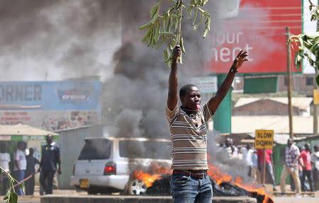 A supporter of the opposition National Super Alliance (NASA) coalition blows a whistle during a demonstration calling for the removal of Independent Electoral and Boundaries Commission (IEBC) officials in Kisumu, Kenya September 26, 2017. REUTERS/James Keyi