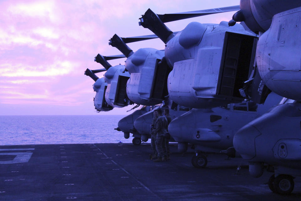 Marines from the 26th Expeditionary Unit stand next to MV22 Ospreys tiltrotor military aircraft on the deck of the USS Bataan in the Aegean Sea, Greece, Friday, Jan. 19, 2024. The Bataan, an amphibious assault ship, is leading a U.S. Navy task force in the eastern Mediterranean as the United States maintains an increased level of military deployment in the Middle East. (AP Photo/Derek Gatopoulos)