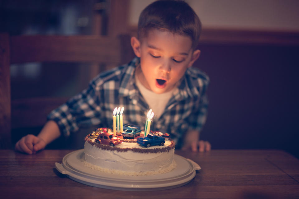 a kid blowing out a candle