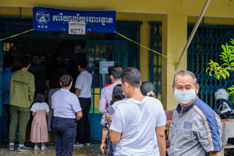 Voters line up at a school polling station on Sunday morning. Photo by Thomas Maresca/UPI