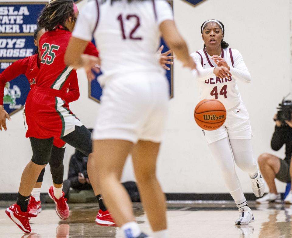 Lawrence Central High School junior Laila Abdurraqib (44) makes a pass to a teammate during the first half of an IHSAA Class 4A Sectional semi-final basketball game against Lawrence North High School, Friday, Feb. 2, 2024, at Cathedral High School.