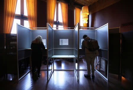 Dutch voters fill in their ballots for the European elections in polling booths at the Central Station in Amsterdam, Netherlands May 23, 2019. REUTERS/Eva Plevier