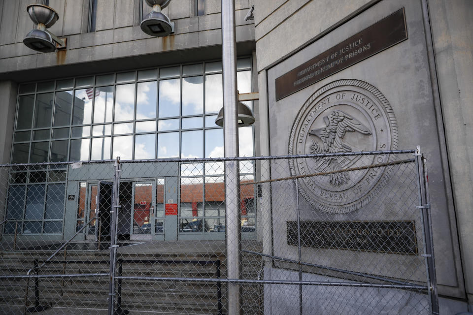 Fencing stands outside the main entrance of the Metropolitan Detention Center, Brooklyn where British socialite Ghislaine Maxwell is held, Tuesday, July 14, 2020, in New York. Jeffrey Epstein's former girlfriend has been denied bail and will remain behind bars on charges she recruited girls and women for the financier to sexually abuse more than two decades ago. (AP Photo/John Minchillo)