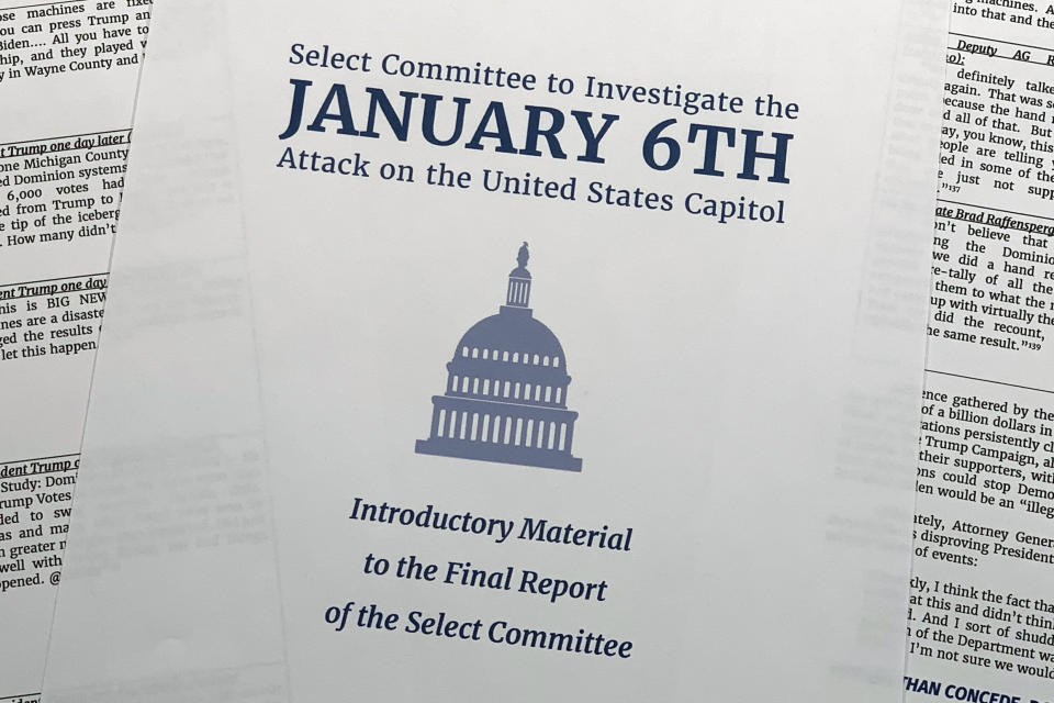 Pages of the executive summary from the House select committee investigating the Jan. 6 attack on the U.S. Capitol, are photographed Monday, Dec. 19, 2022, in Washington. The committee is urging the Justice Department to bring criminal charges against former President Donald Trump, delivering what it calls a "roadmap to justice" in response to the violent 2021 Capitol insurrection.(AP Photo/Jon Elswick)