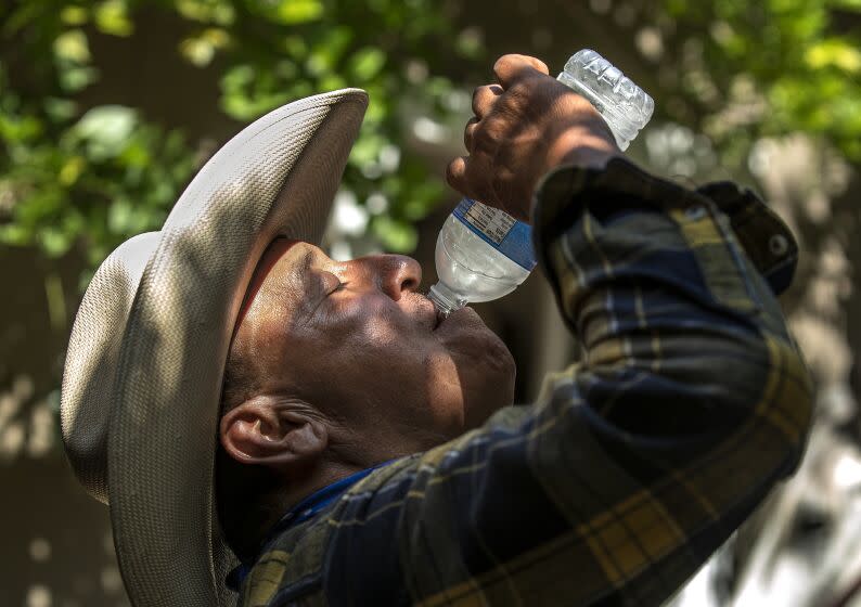 GLENDALE, CA-APRIL 28, 2023: Ben Rodriguez cools off with a bottle of water after exercising horses for a customer in Glendale on Friday afternoon. Highs for much of Southern California will peak Saturday as the state braces for the warmest temperatures so far this year. (Mel Melcon / Los Angeles Times)